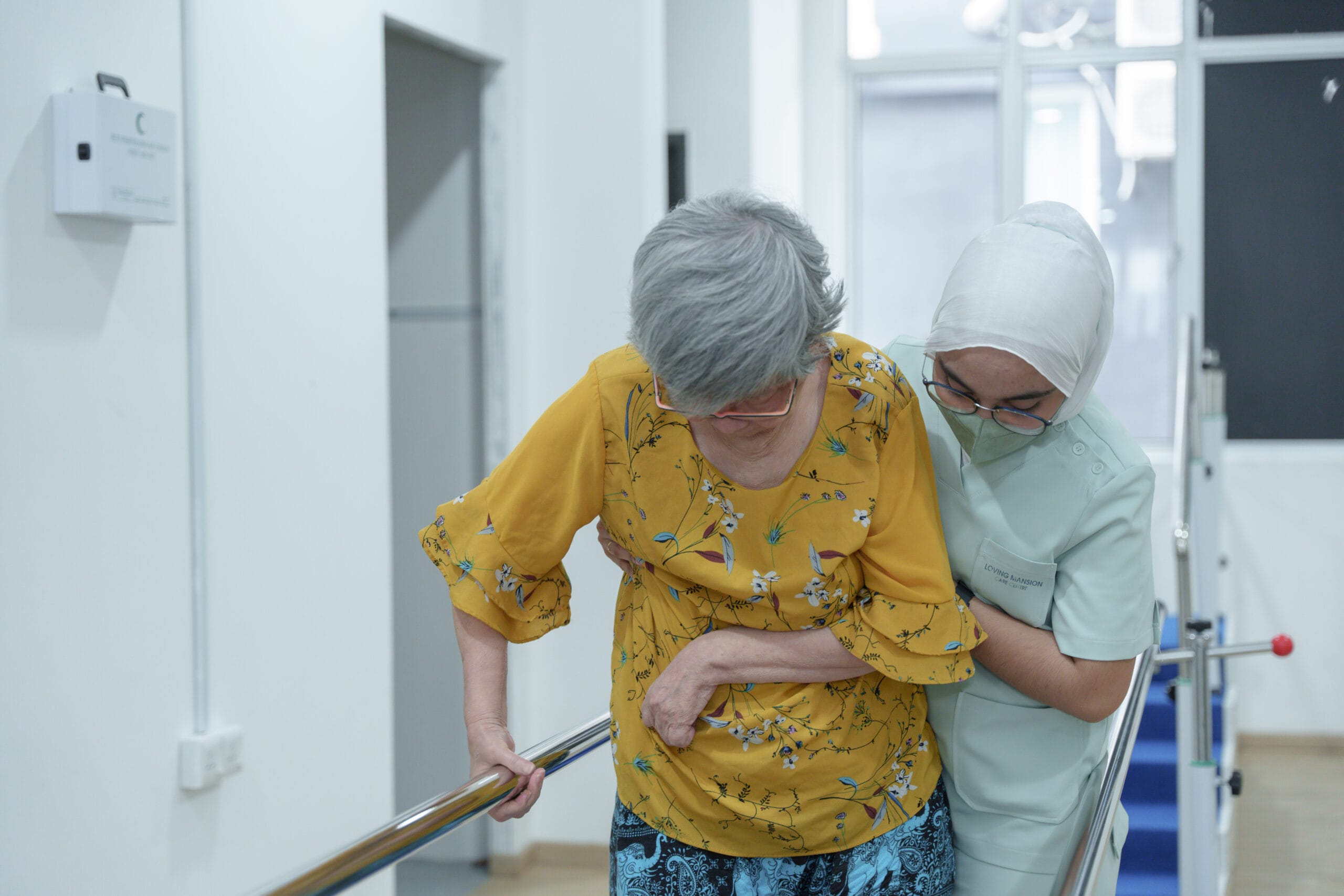 helping an old lady at a nursing home
