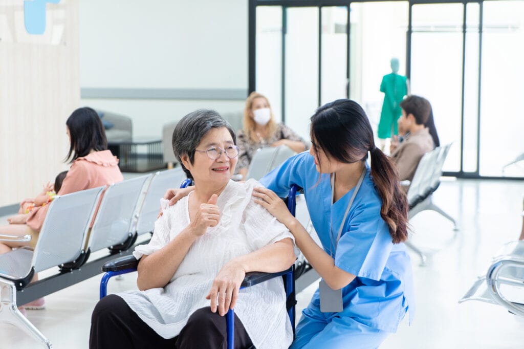 old woman being served by a nurse at the waiting room