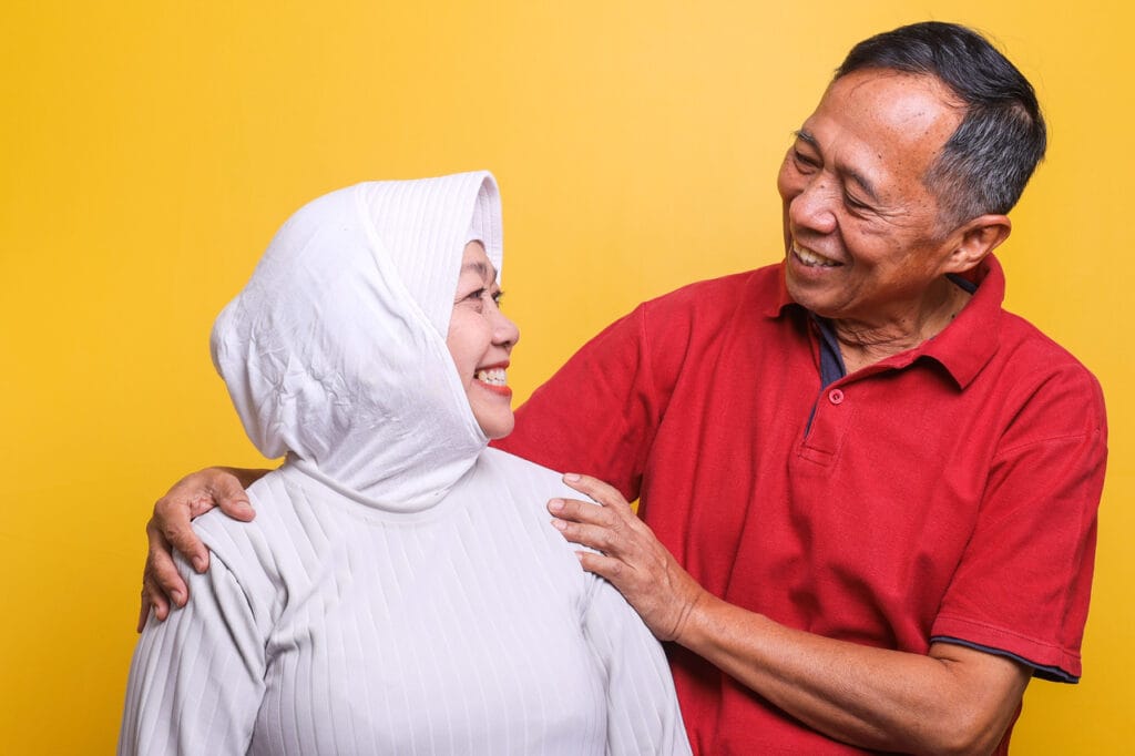 Malay muslim couple smiling at each other